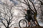 Man with mountain bike in countryside