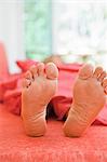 woman sleeping with feet out from covers