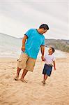 young mexican father and son on beach