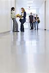 High school students talking in school corridor