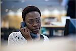 Female office worker talking on phone