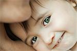 Baby leaning against mother's chest, portrait