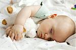 Infant sleeping with stuffed toy