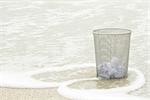 Wastepaper basket on beach