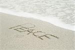 The word "peace" written in the sand at the beach