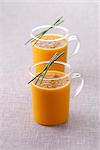 Glass cups of carrot soup