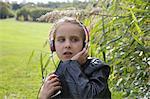 Young Girl Sitting Outside Listening to Music
