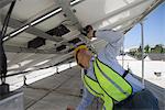 Maintenance worker adjusting solar panel in Los Angeles, California
