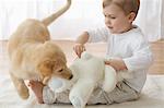Little Boy With Goldendoodle Puppy