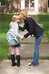 Mother Kissing Daughter Goodbye in Front of School