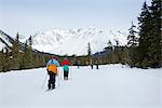 A group of friends cross country ski and snowshoe on the multi-use Moose Meadow trail near the Alyeska Hotel in Girdwood, Southcentral Alaska, Spring