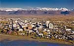 Aerial view of the Anchorage skyline looking south over Knik Arm with the Chugach Mountains in the background during Fall, Southcentral Alaska