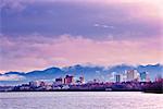 Skyline view of the sun rising over a fog shrouded Anchorage and Cook Inlet, Southcentral Alaska, Fall