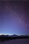 Night time view of Mt. McKinley with a star filled sky, the Milky Way, and a shooting star overhead, Denali State Park, Southcentral Alaska, Winter