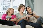 Teenagers playing on games console