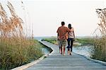 Couple walking on beach walkway