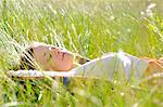 Jeune femme faire la sieste dans l'herbe haute