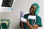 Nurse checking medical equipment monitor