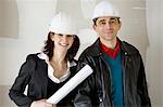 Architect and building contractor in hard hats, portrait