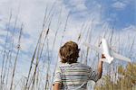 Boy playing with toy airplane