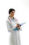 Doctor wearing stethoscope and writing on chart