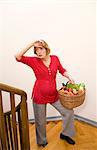 exhausted pregnant woman carrying basket