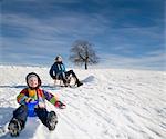 Boy and Girl riding a sledge in snow