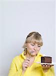 woman looking at plate of cake