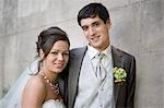 Bridal couple smiling at the camera.