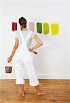 Woman looking at colour swatches on wall