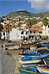 Drying salt cod (bacalhau) and fishing boats in the small south coast harbour of Camara de Lobos, Madeira, Portugal, Atlantic, Europe