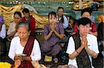 Women praying at the Shwe Dagon Pagoda (Shwedagon Paya), Yangon (Rangoon), Myanmar (Burma), Asia