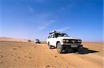 Jeeps driving through desert, Erg Murzuq, Sahara desert, Fezzan, Libya, North Africa, Africa