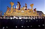 Religious float being carried through the streets during Semana Santa (Holy Week) celebrations, Malaga, Andalucia, Spain, Europe