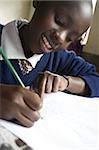 Schoolgirl working happily at school, pupil at Murindati Primary School, Rift Valley, Kenya, East Africa, Africa