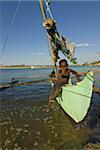 Young boy in a outrigger canoe, Antsanitian Beach Resort, Mahajanga, Madagascar, Africa
