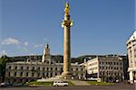 Golden Statue of St. George, with Freedom Hall behind, on Tavisuplebis Moedani (Freedom Square), Tiblisi, Georgia, Caucasus, Central Asia, Asia