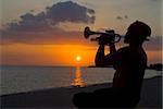 Trumpet player at sunset, Playa Ancon, Trinidad, Cuba, West Indies, Caribbean, Central America