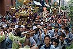 A mikoshi (portable shrine) being carried through the streets during the Sanja Festival in Asakusa, Tokyo, Japan, Asia