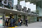 Business people at the contemporary glass entrance on the Otemachi side of Tokyo Station, Japan, Asia