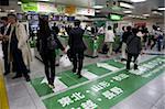 Passengers hurrying through automatic ticket wickets on their way to bullet train platforms at Tokyo Station, Japan, Asia