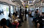 Passengers riding aboard the Yamanote loop line train that encircles greater metropolitan Tokyo, Japan, Asia