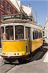 A number 28 tram runs along the scenic route popular with tourists in the Alfama district of Lisbon, Portugal, Europe