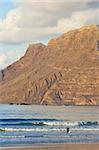 Spectacular 600m volcanic cliffs of the Risco de Famara rising over Lanzarote's finest surf beach at Famara in the north west of the island, Famara, Lanzarote, Canary Islands, Spain, Atlantic Ocean, Europe