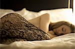 Woman Lying in Bed Wearing Lace Stockings