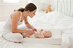 Mother with baby son on changing mat