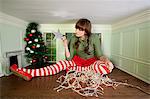 Young woman in small room with christmas decorations