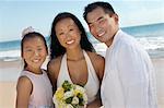 Bride and Groom with sister on beach, (portrait)