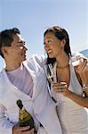 Bride and Groom celebrating with champagne, outdoors