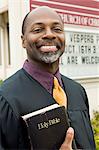 Smiling Preacher in Front of Church, portrait